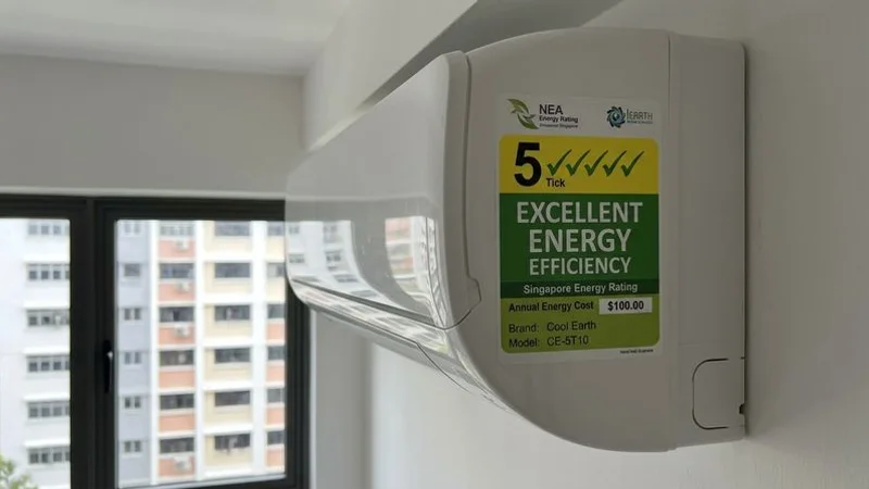 Singapore NEA energy label showing a 5-tick rating on a display model aircon unit in a showroom